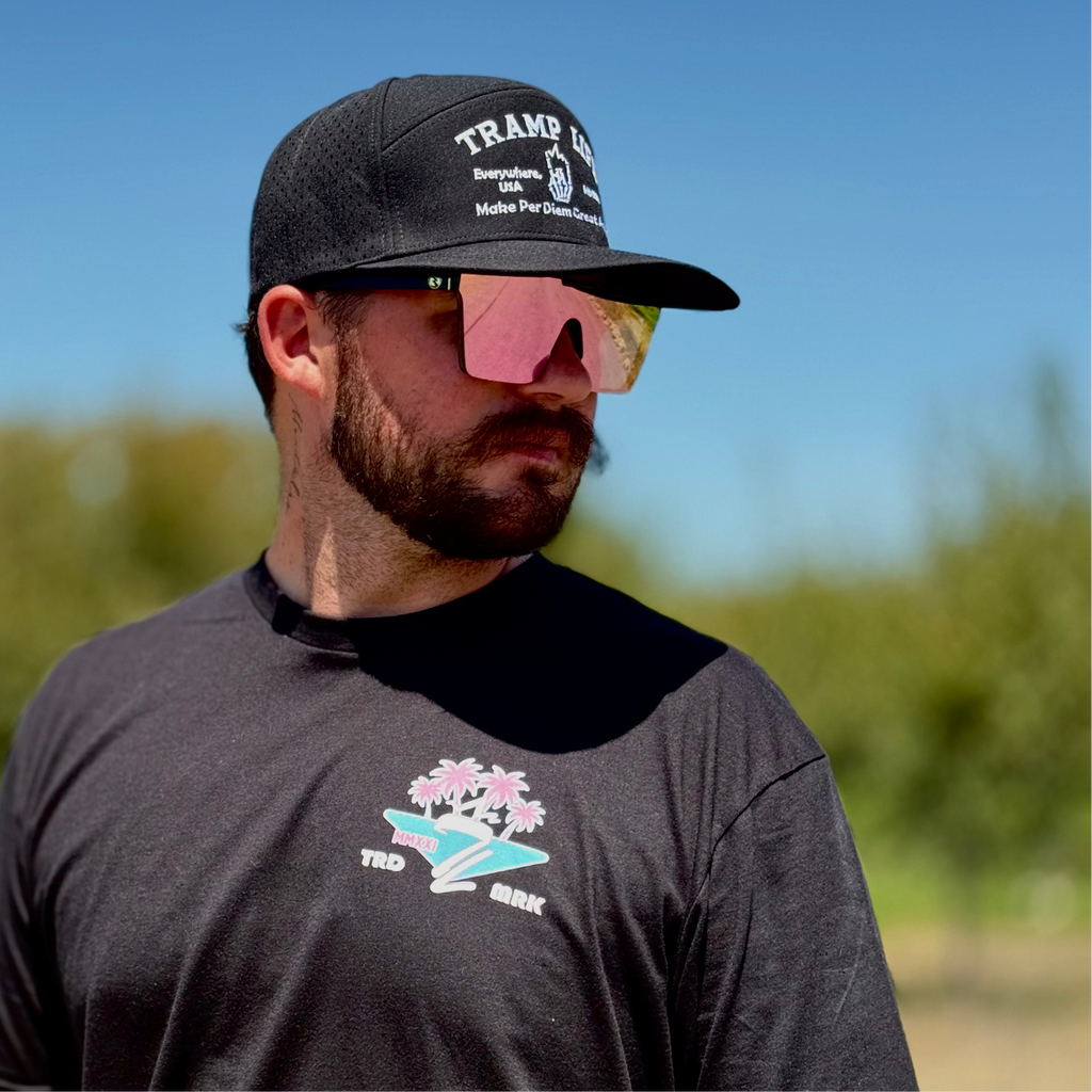 man wearing black waterproof hat from tramp life that says make per diem great again 