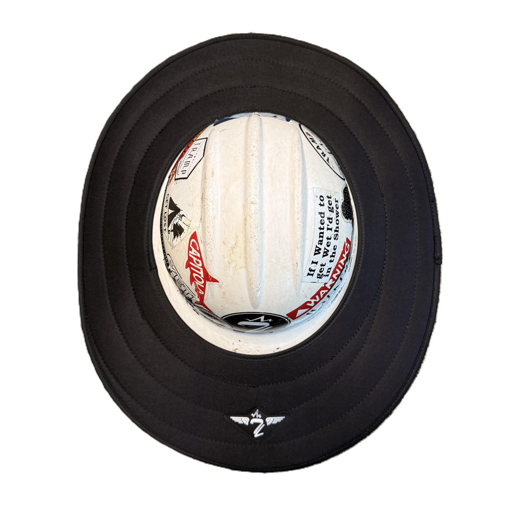 black sunshade from tramp life industries on a white hard hat with stickers