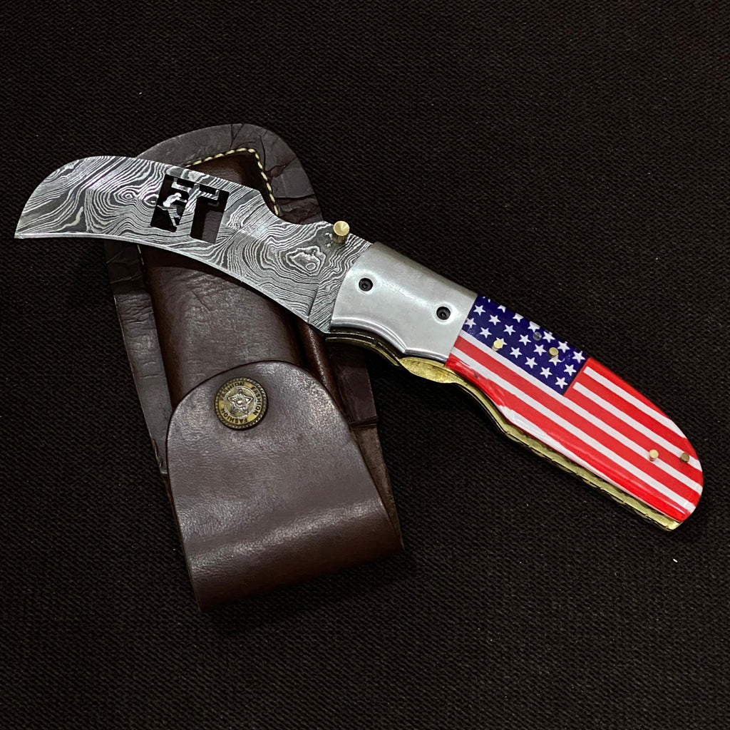 Knife with American flag handle on a dark background. lineman cut out in the blade