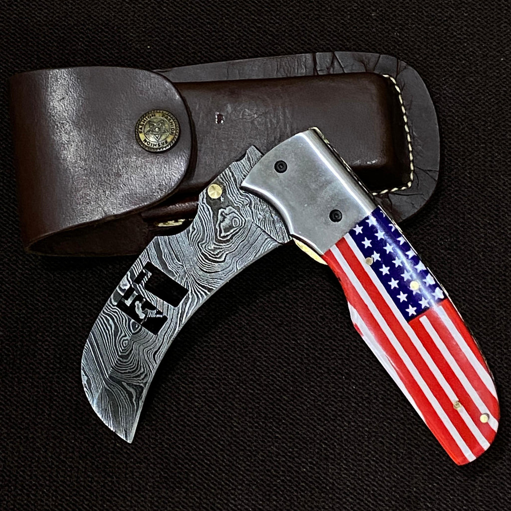 damascus steel knife with a lineman etched out in it. glass handle with american flag print