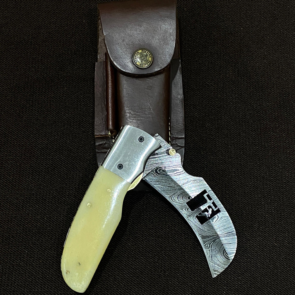 a camel bone hawksbill knife made by lineman knives