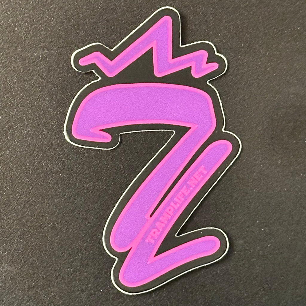 a purple tl from tramp life with pink outline. vinyl sticker
