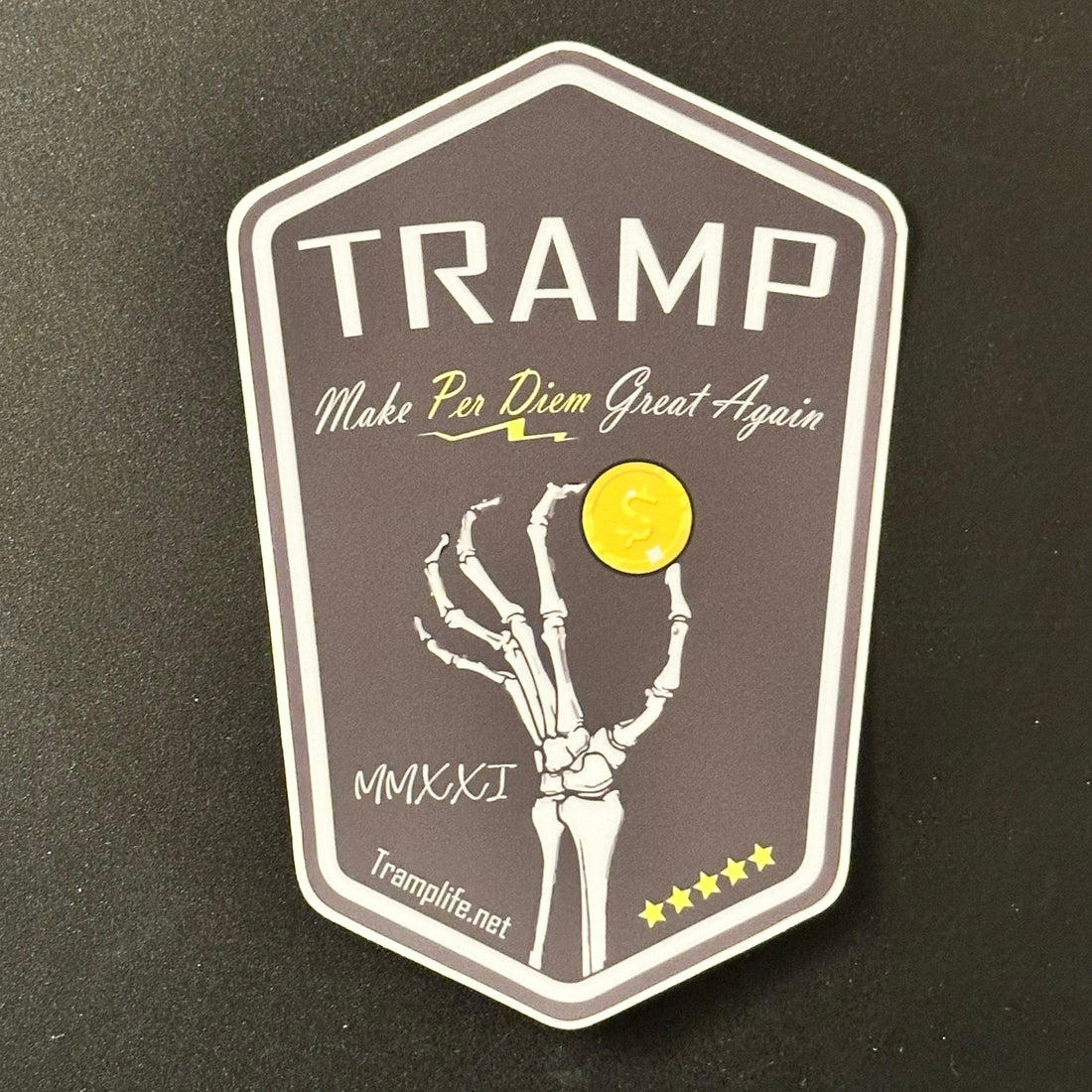 Hexagonal sticker with 'TRAMP' branding on a dark background
