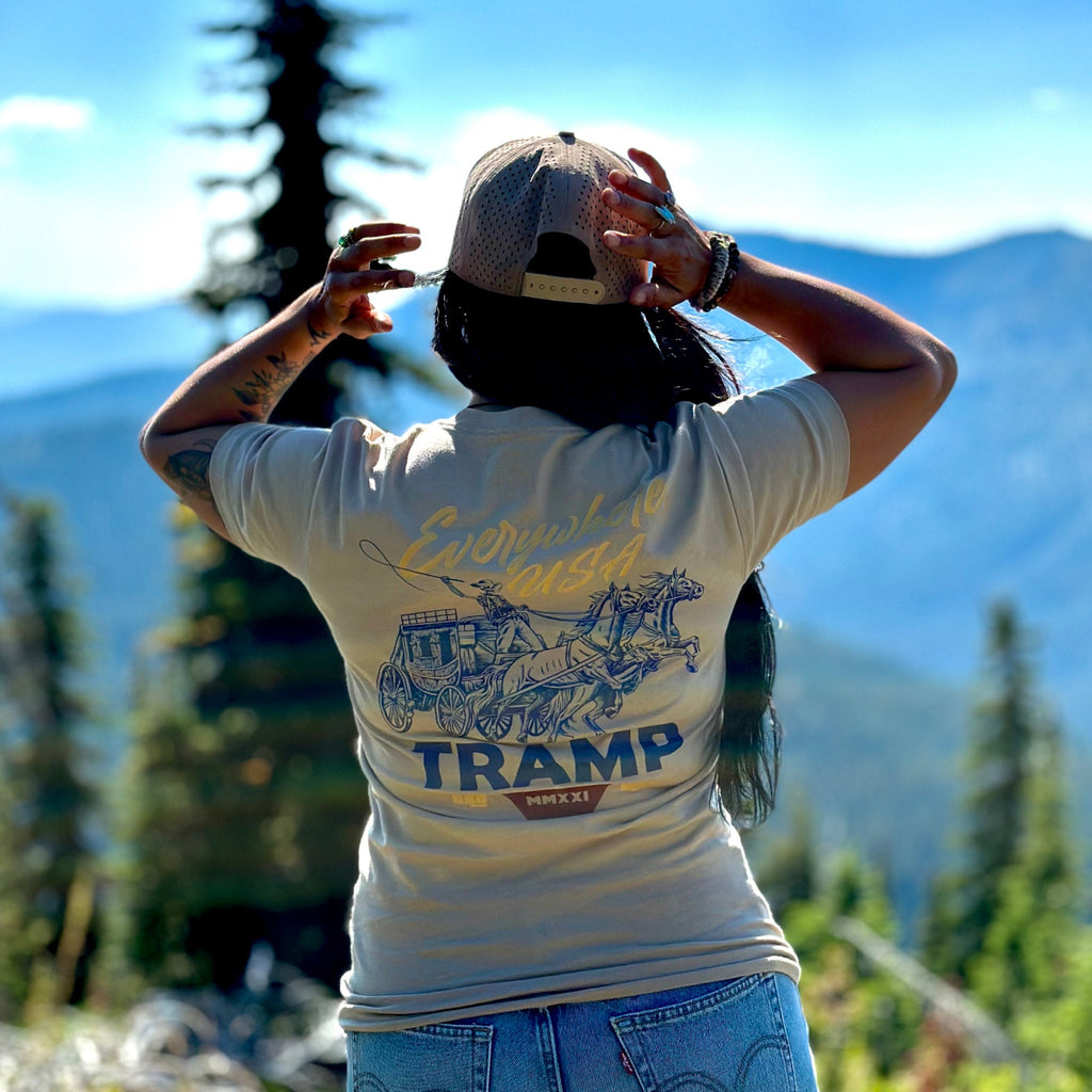 woman standing on mountain with the tramp wagon shirt on 