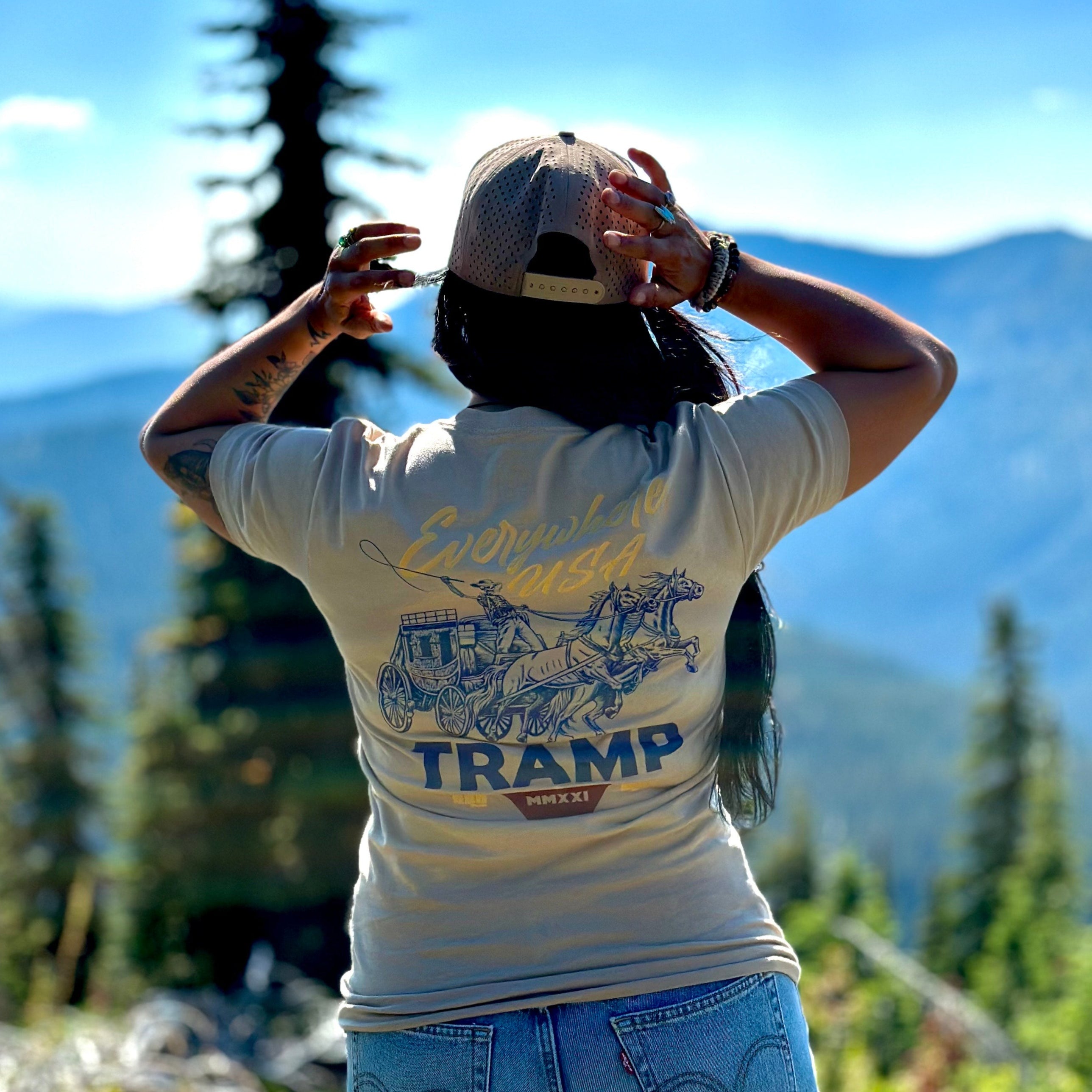 woman standing on mountain with the tramp wagon shirt on 