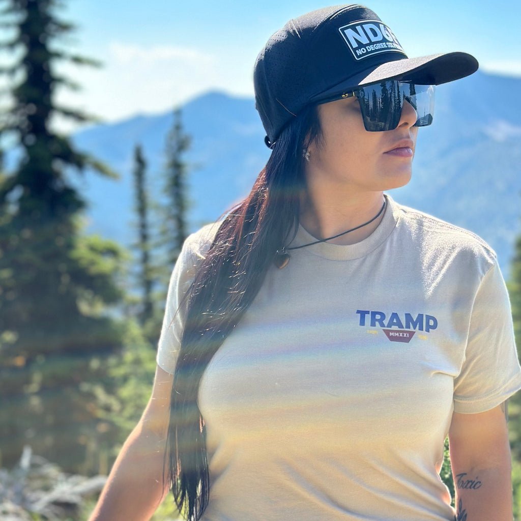 woman standing on a mountain with the tramp wagon shirt