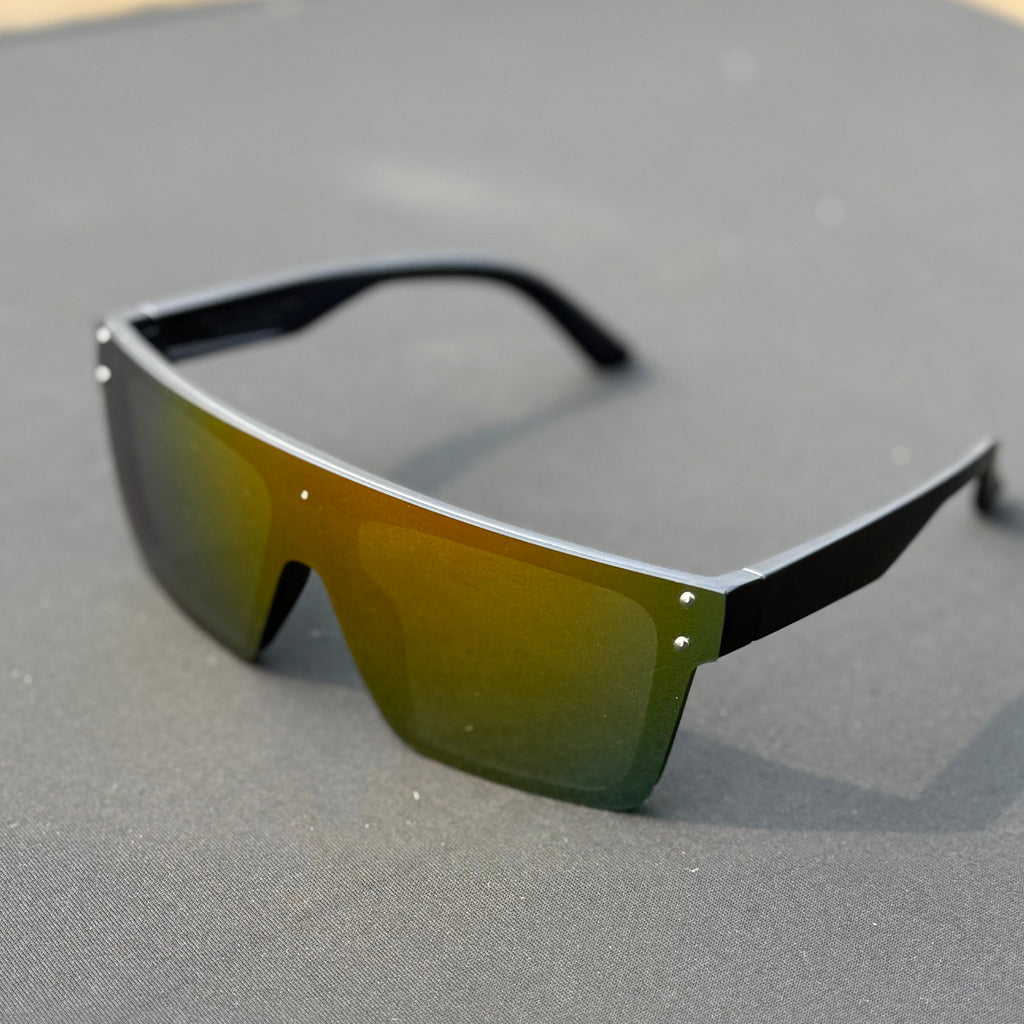 Sunglasses with green reflective lenses on a gray surface