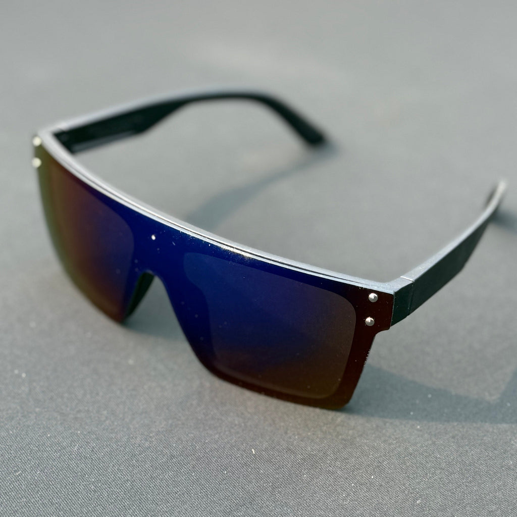 Sunglasses with blue-tinted lenses on a gray surface