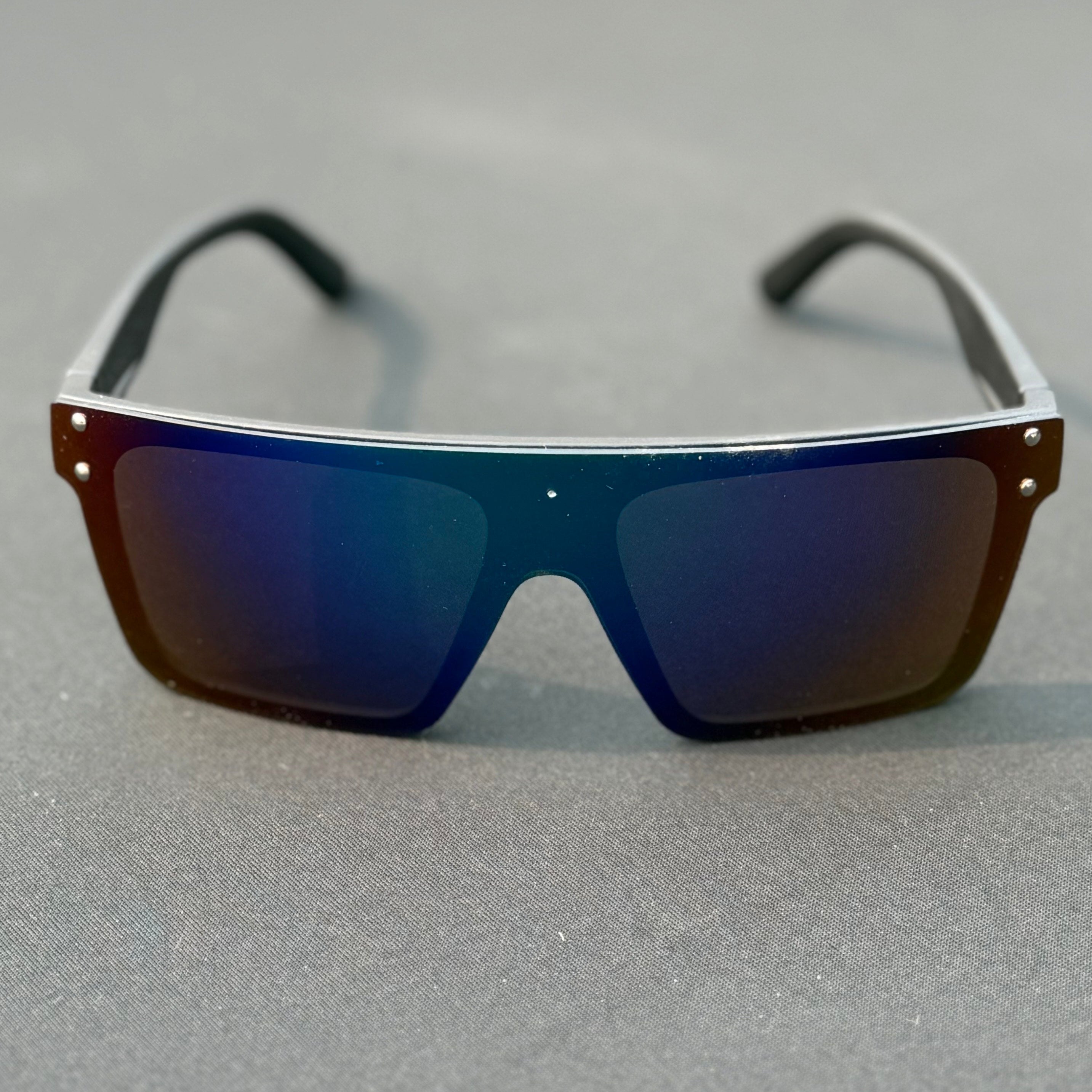 Sunglasses with blue reflective lenses on a gray surface