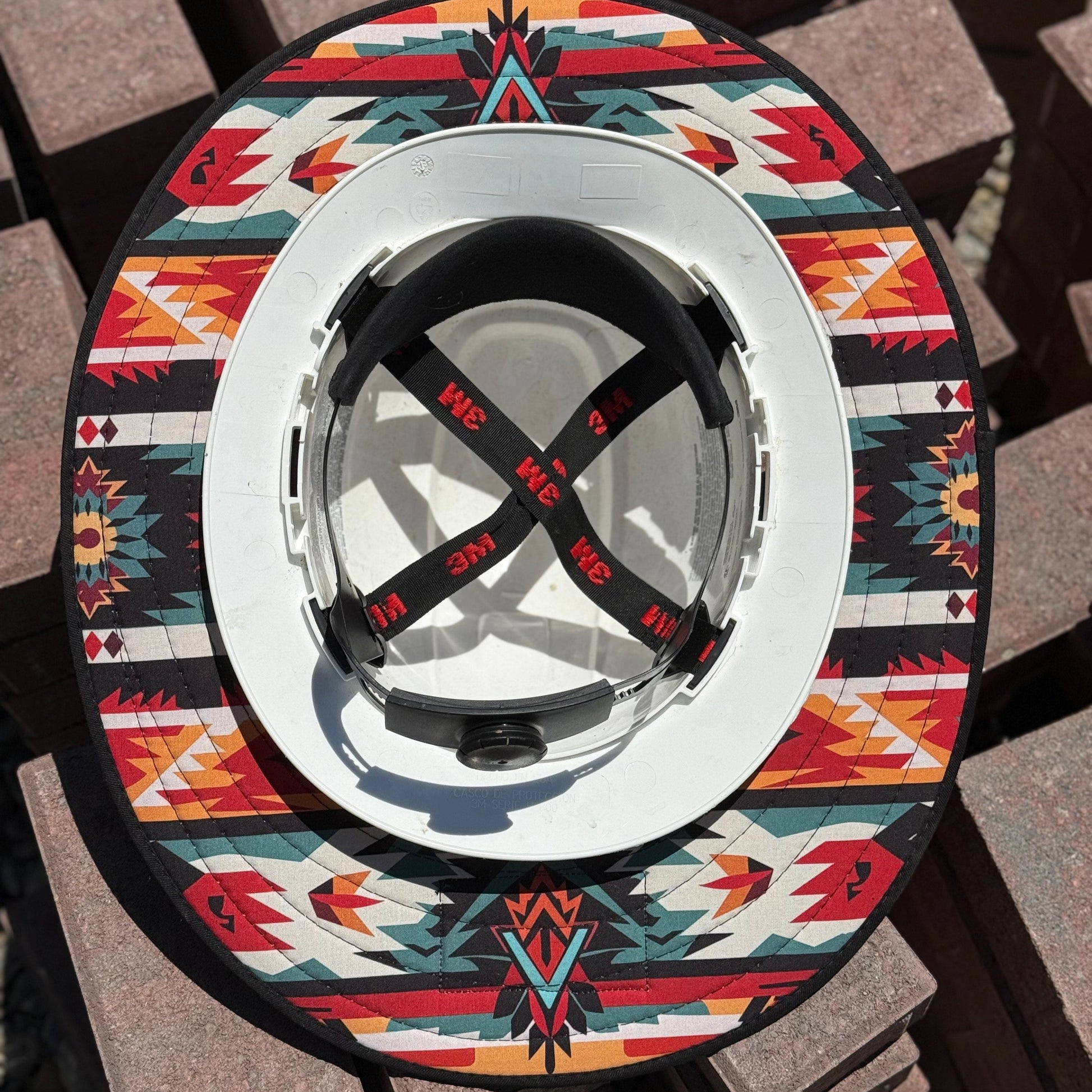 red pendleton sunshade from tramplife on a hard hat on some bricks