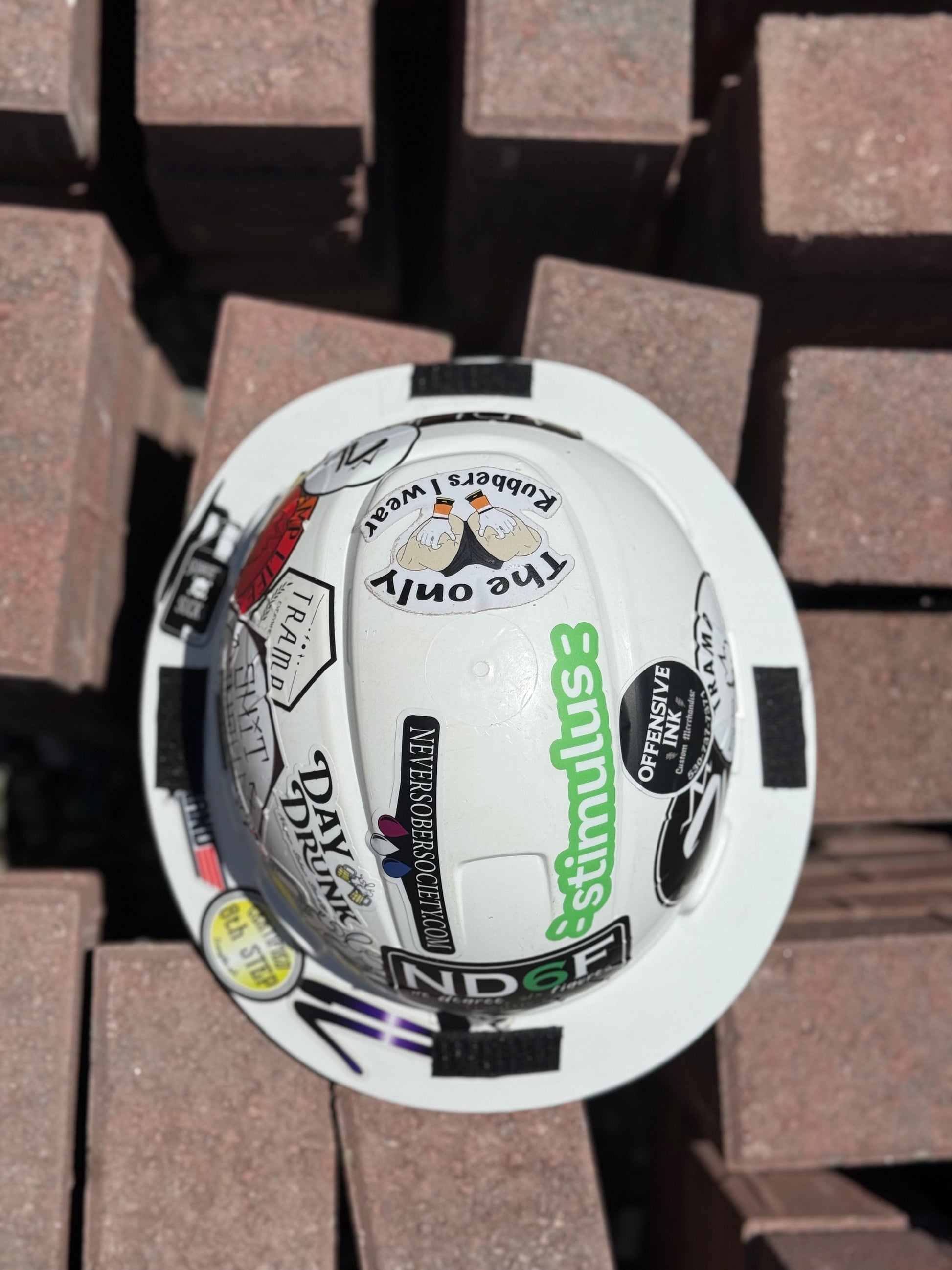 a white hard hat with the velcro for a sunshade on it showing how the sunshade is connected to the hardhat