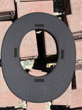 an all black sunshade made for a hardhat upside down showing the velcro that is sewn into the bottom of it showing where it attaches to a hard hat