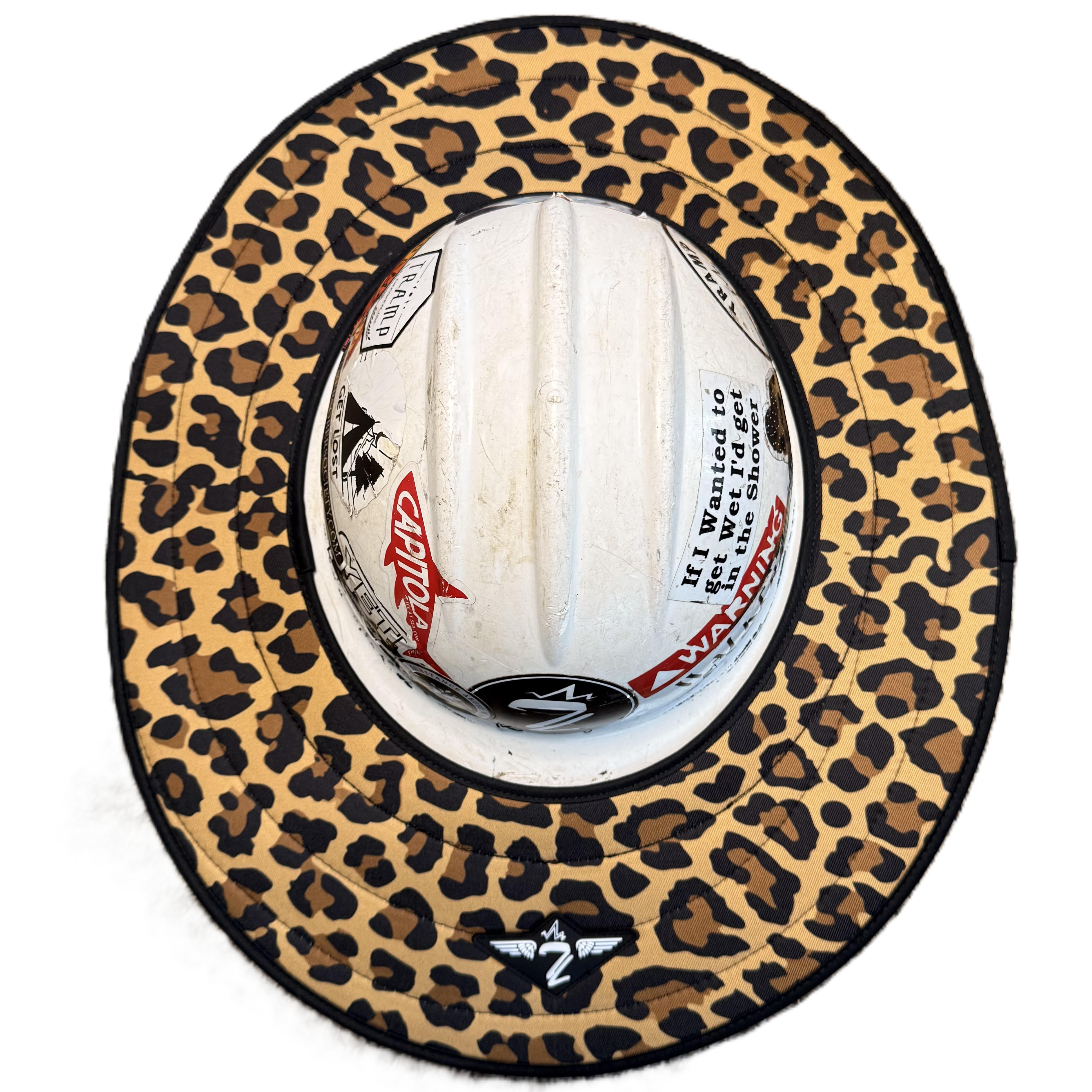 leopard print sunshade from tramp life industries. goes around a hard hat for weather protection. sunshade is on a white hard hat with stickers