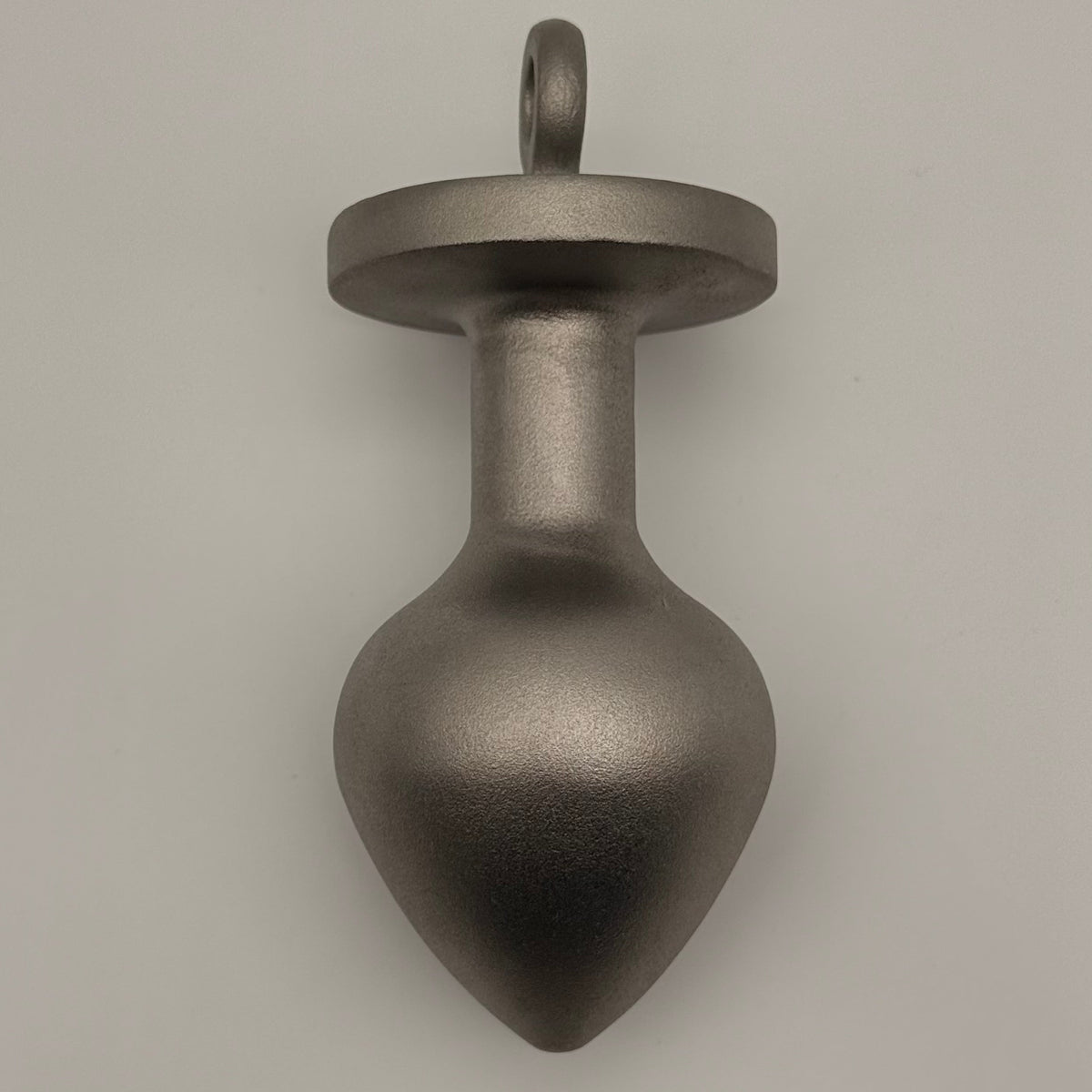 the plug plumb bob from tramp life industries. resembles a butt plug plumb bob. made from stainless steel 304. side view