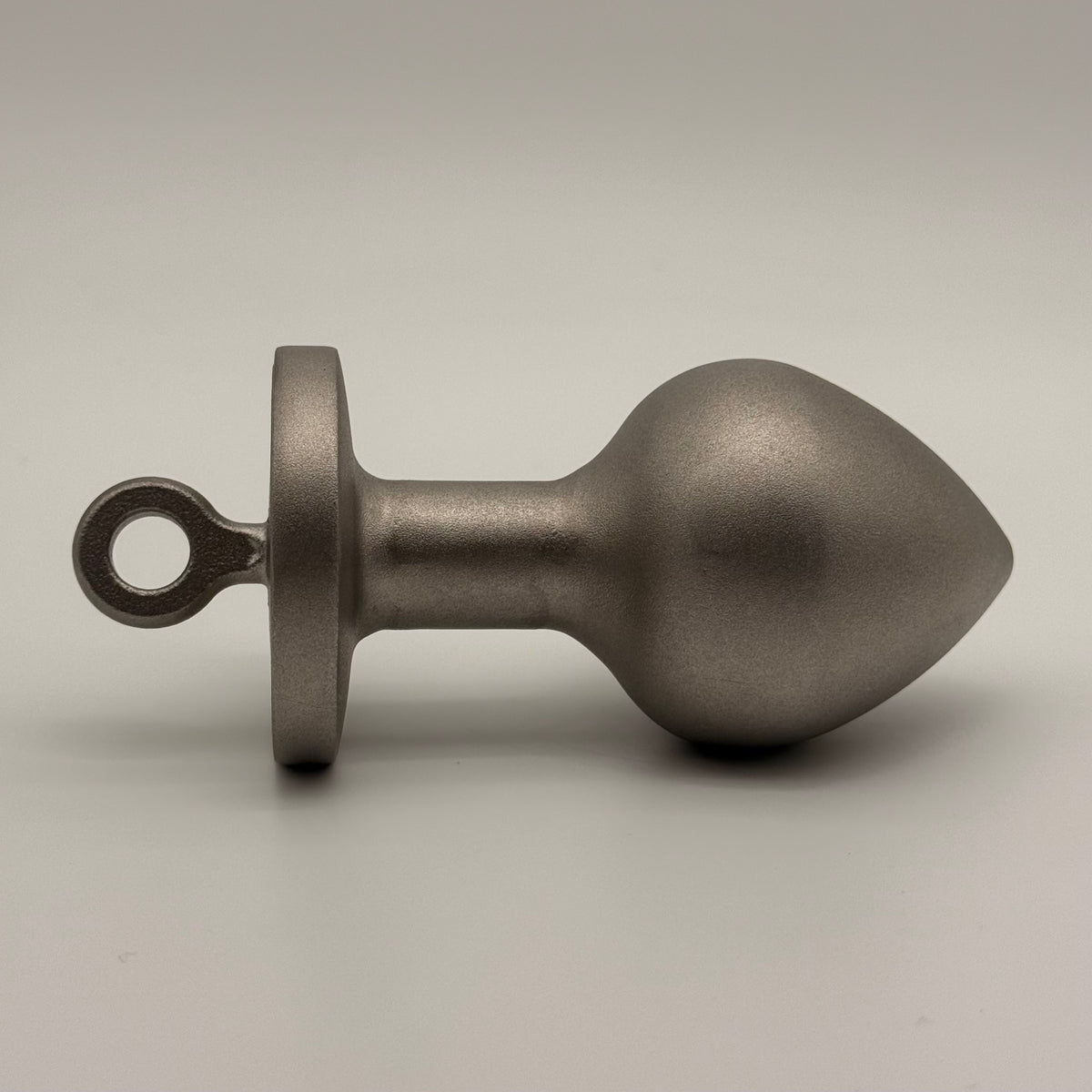 the plug plumb bob from tramp life industries. resembles a butt plug plumb bob. made from stainless steel 304. side view 2