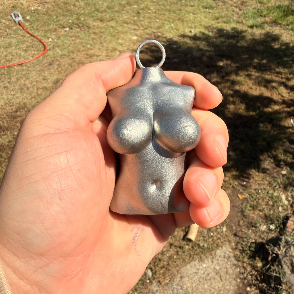 Tramp Life Industries Top Heavy stainless steel plumb bob tool, female torso layout weight gift for linemen and blue-collar workers. shown in a hand to showcase size