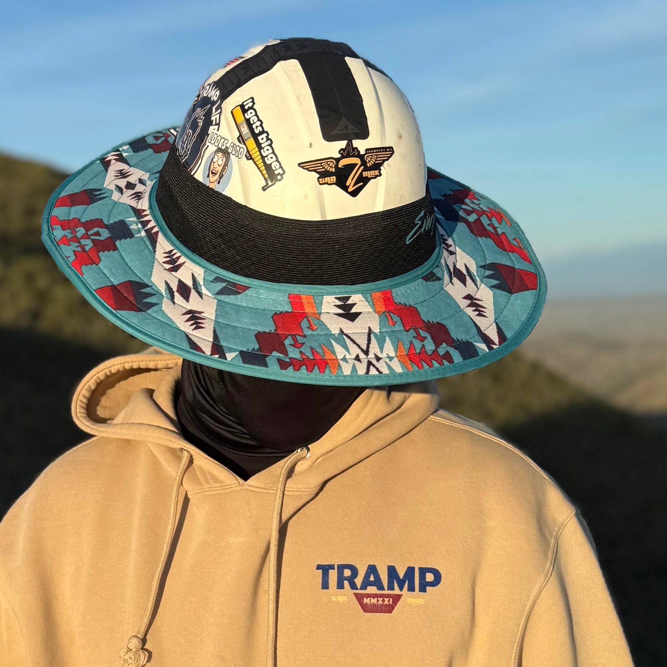 person wearing a turquoise sunshade from tramp life. attaches to hard hats with no brim