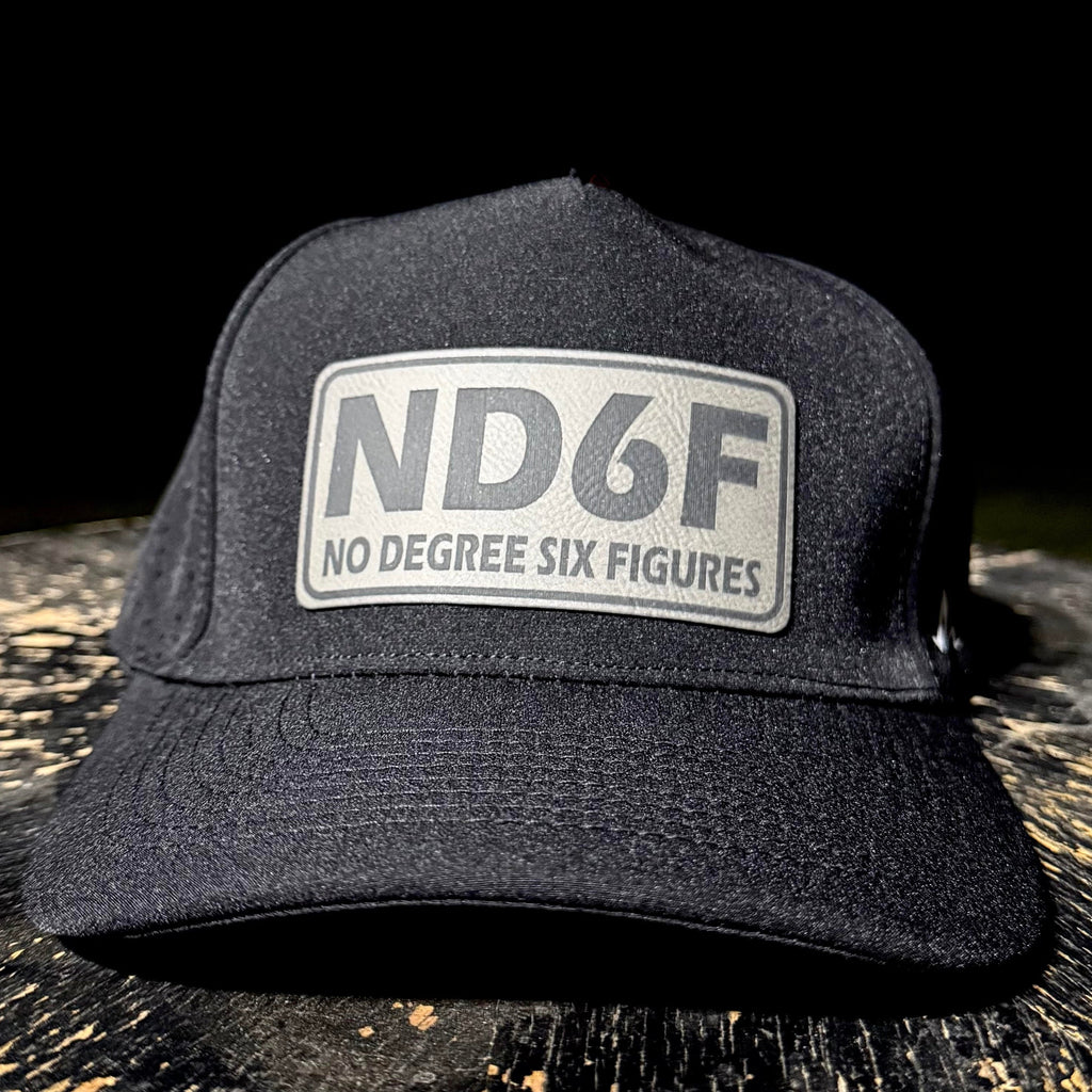 Black cap with 'ND6F No Degree Six Figures' logo on a dark surface
