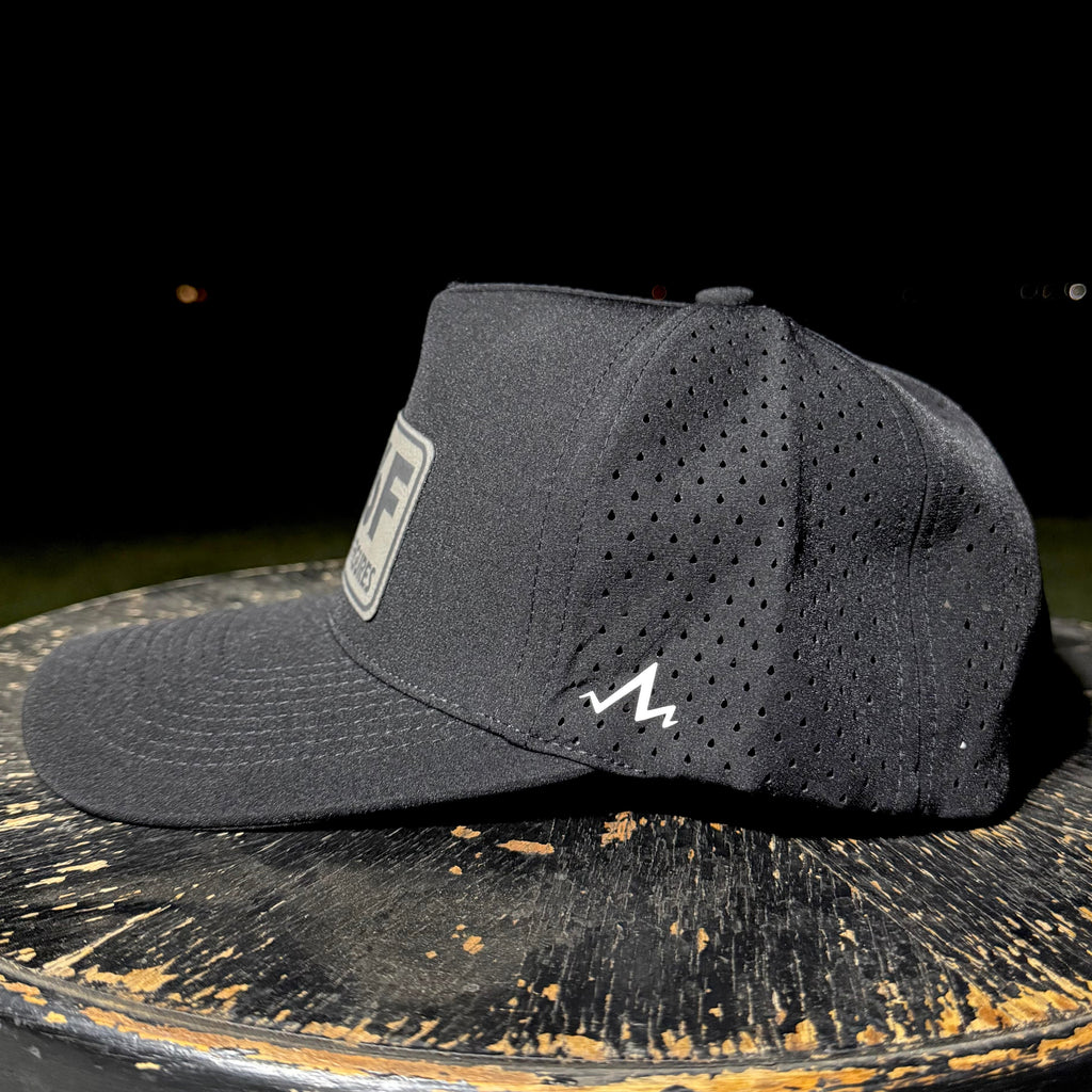 Black cap with a logo on a dark surface