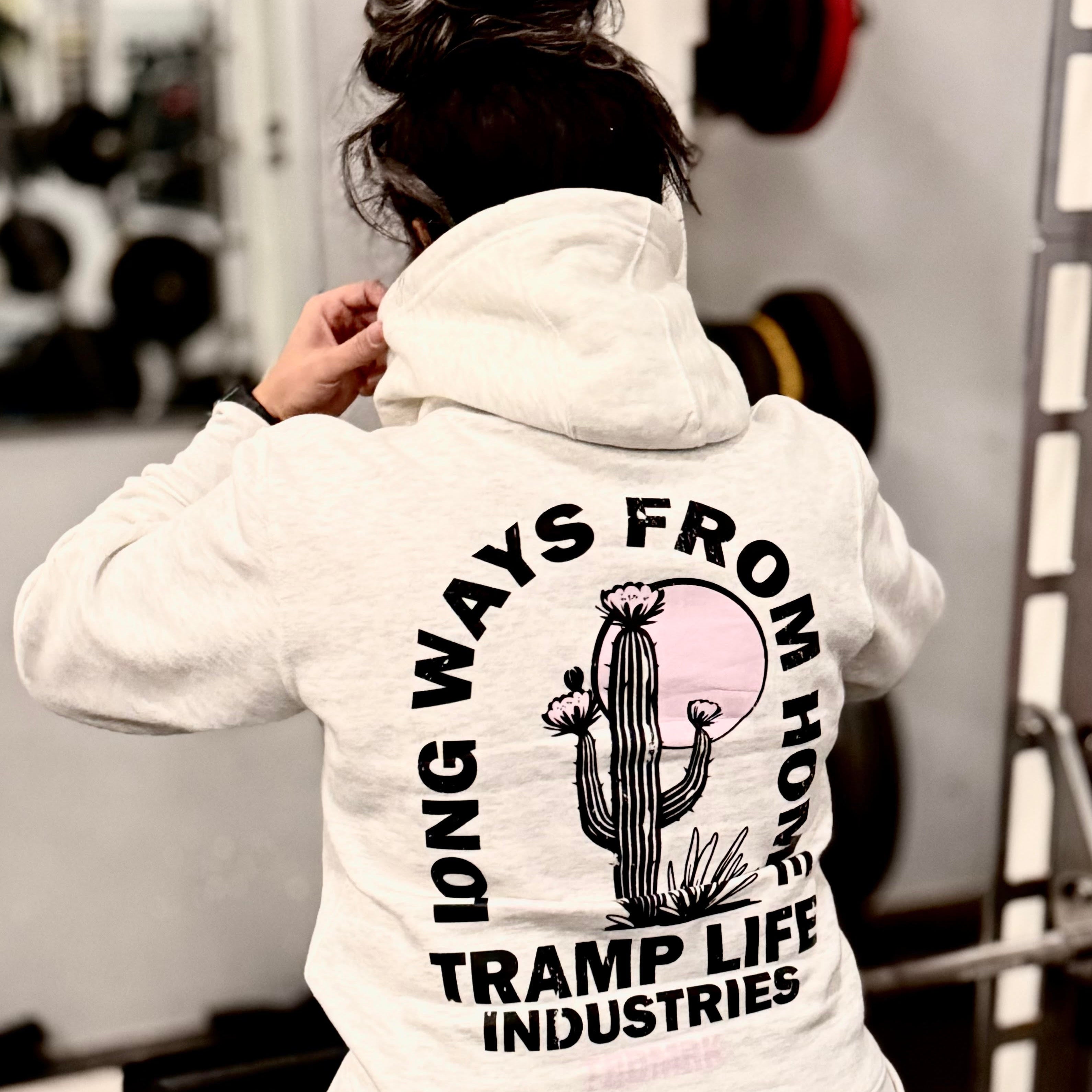 Person wearing a hoodie with a cactus graphic and text in a gym setting
