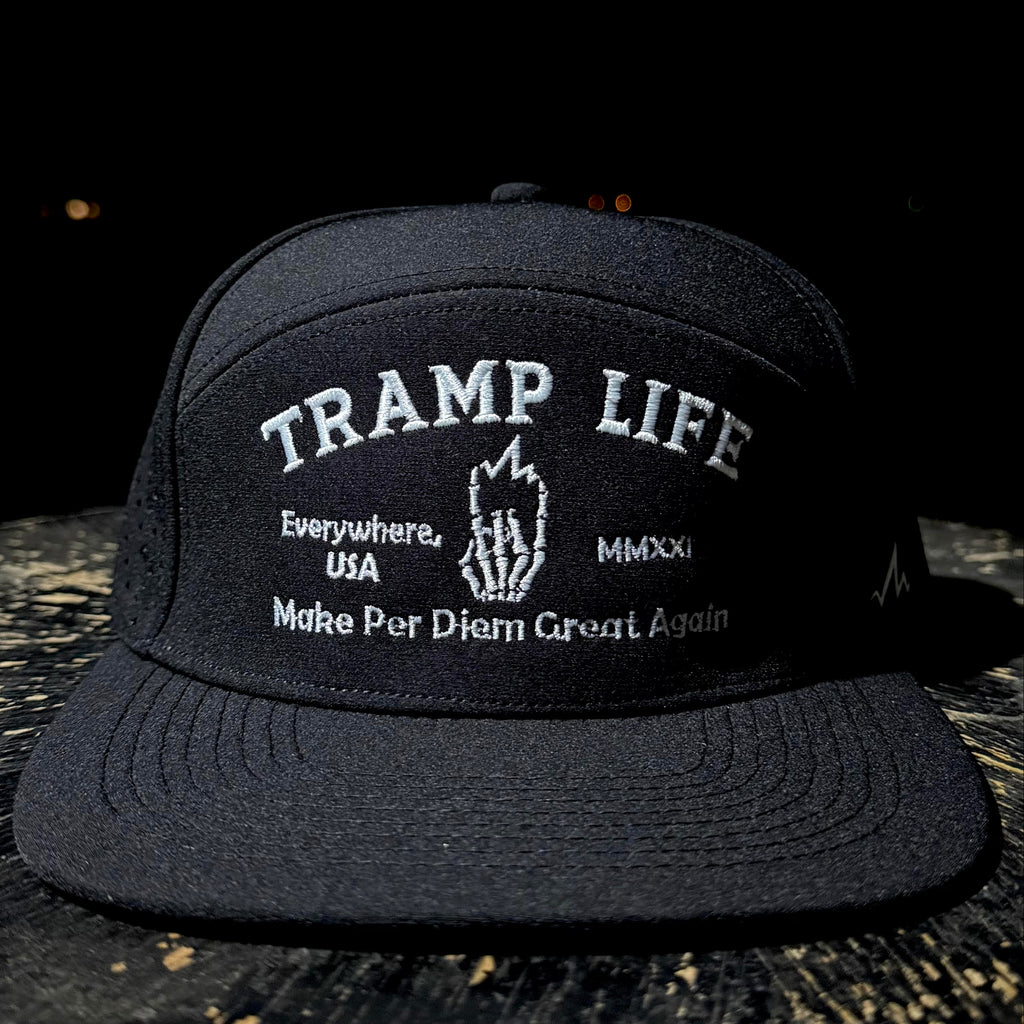 Black cap with 'Tramp Life' text on a dark background