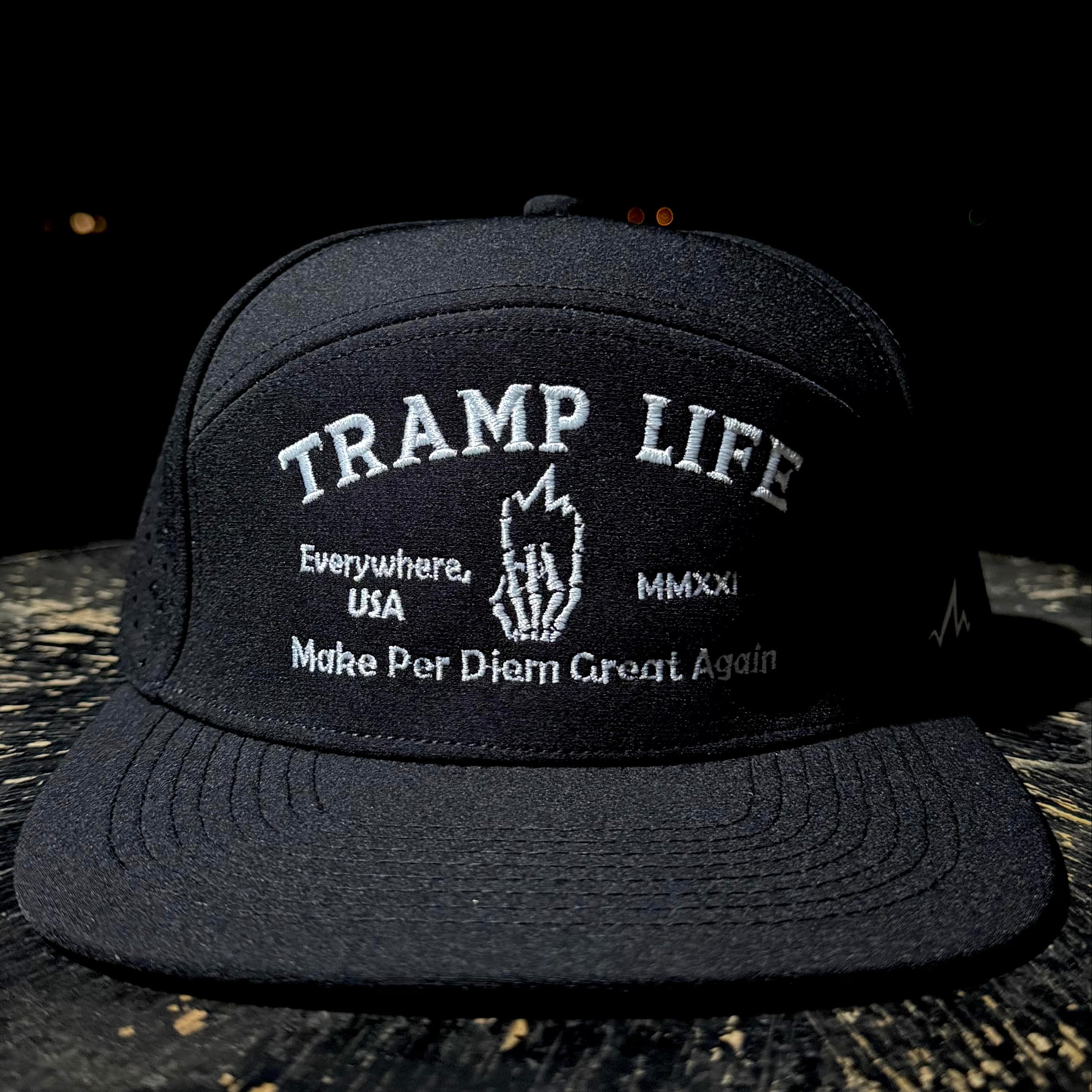 Black cap with 'Tramp Life' text on a dark background