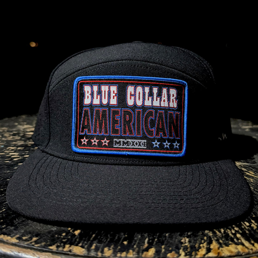Black cap with 'Blue Collar American' patch on a dark surface