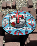 a turquoise sunshade with red, yellow, white and navy accents from tramp life on a white hard hat with tramp life industries stickers sitting on a pile of bricks