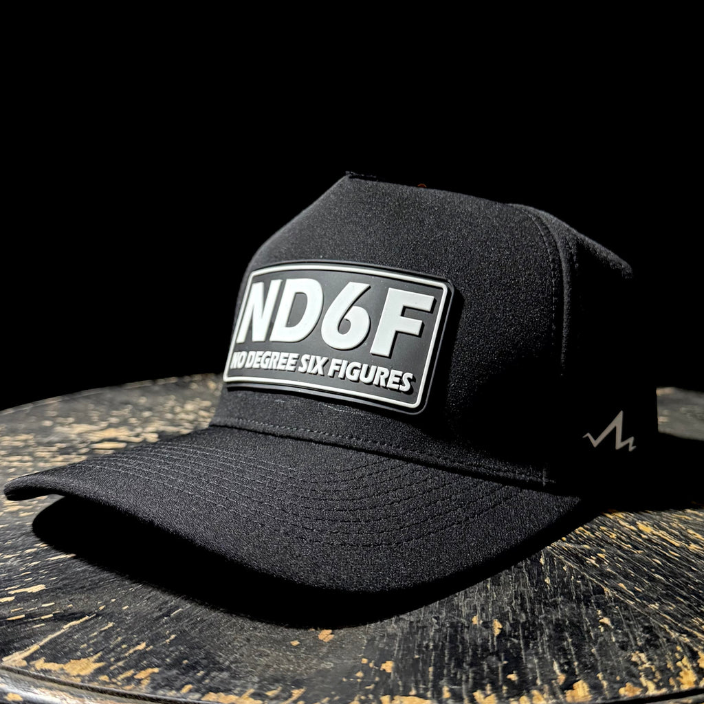 Black cap with 'ND6F' logo on a wooden surface with black background