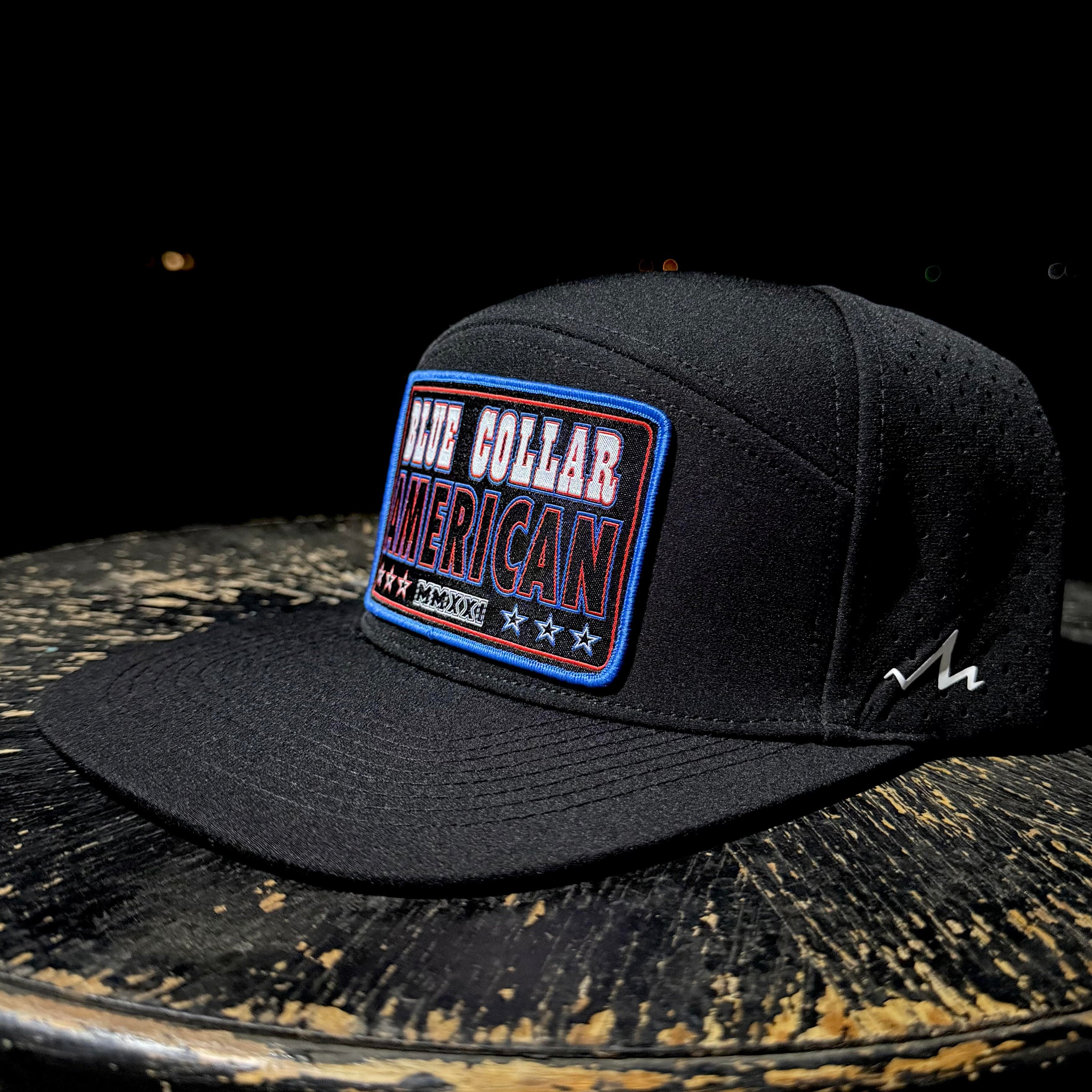 Black cap with a patch on a rustic wooden surface