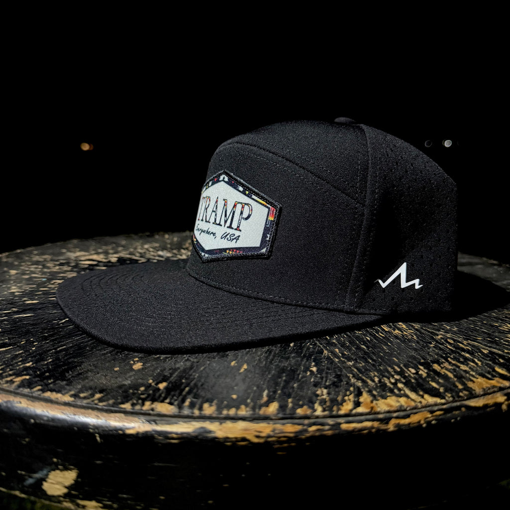 Black cap with a logo on a dark surface