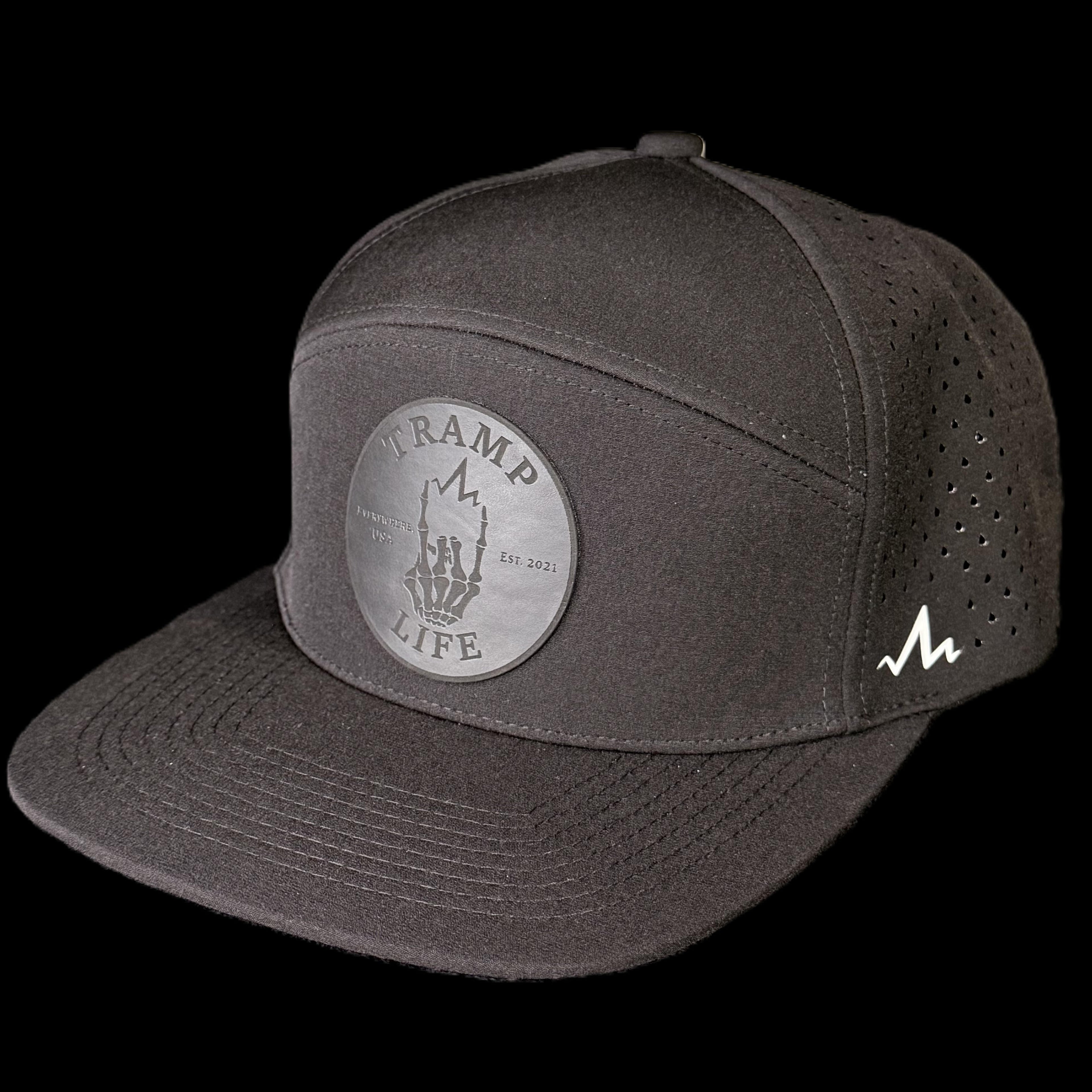 Black hydro rambler snapback hat from tramp life industries. has a black circle patch with the OG design