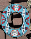 the top side of a turquoise sunshade with red, yellow, white and navy accents from tramp life industries
