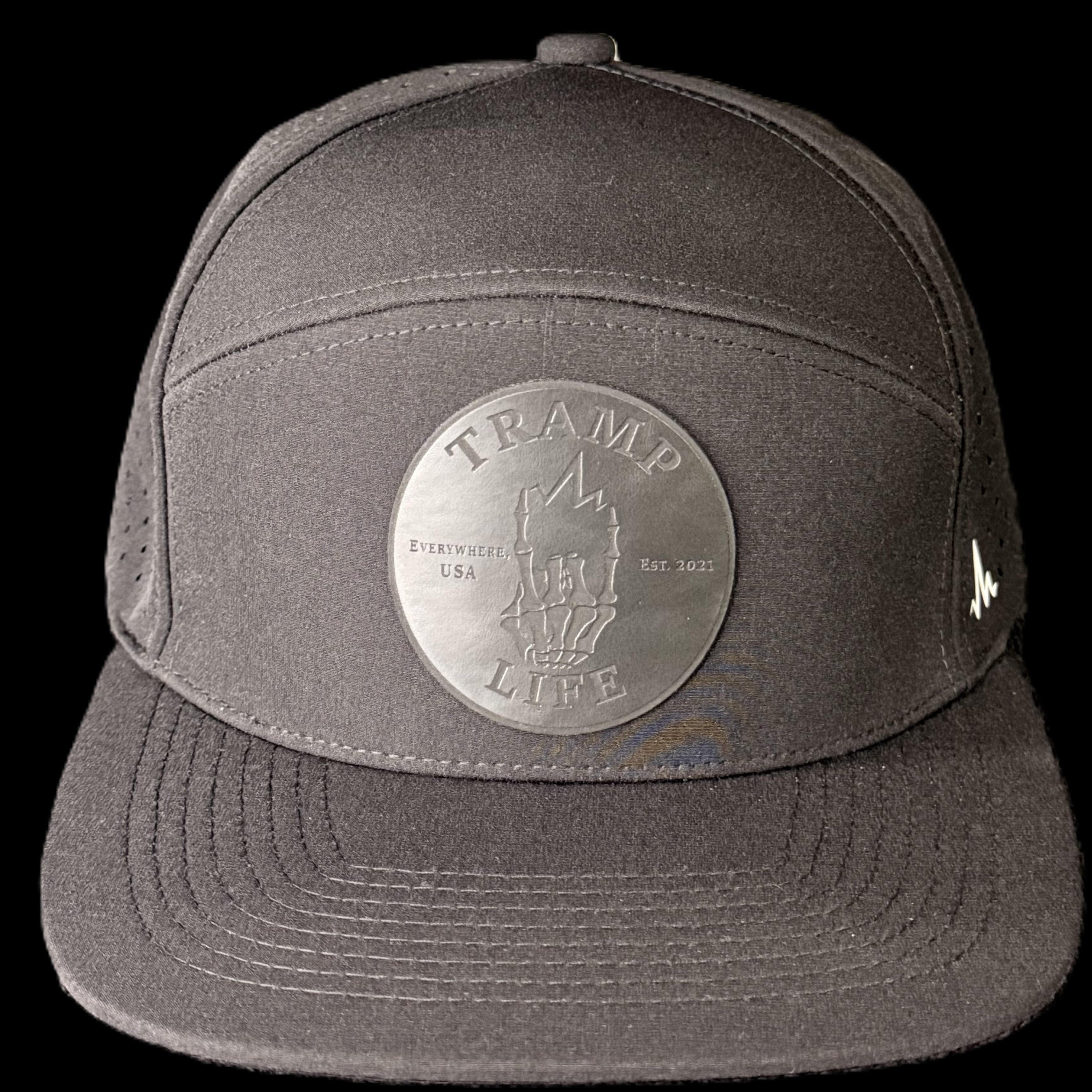 Black hydro rambler snapback hat from tramp life industries. has a black circle patch with the OG design